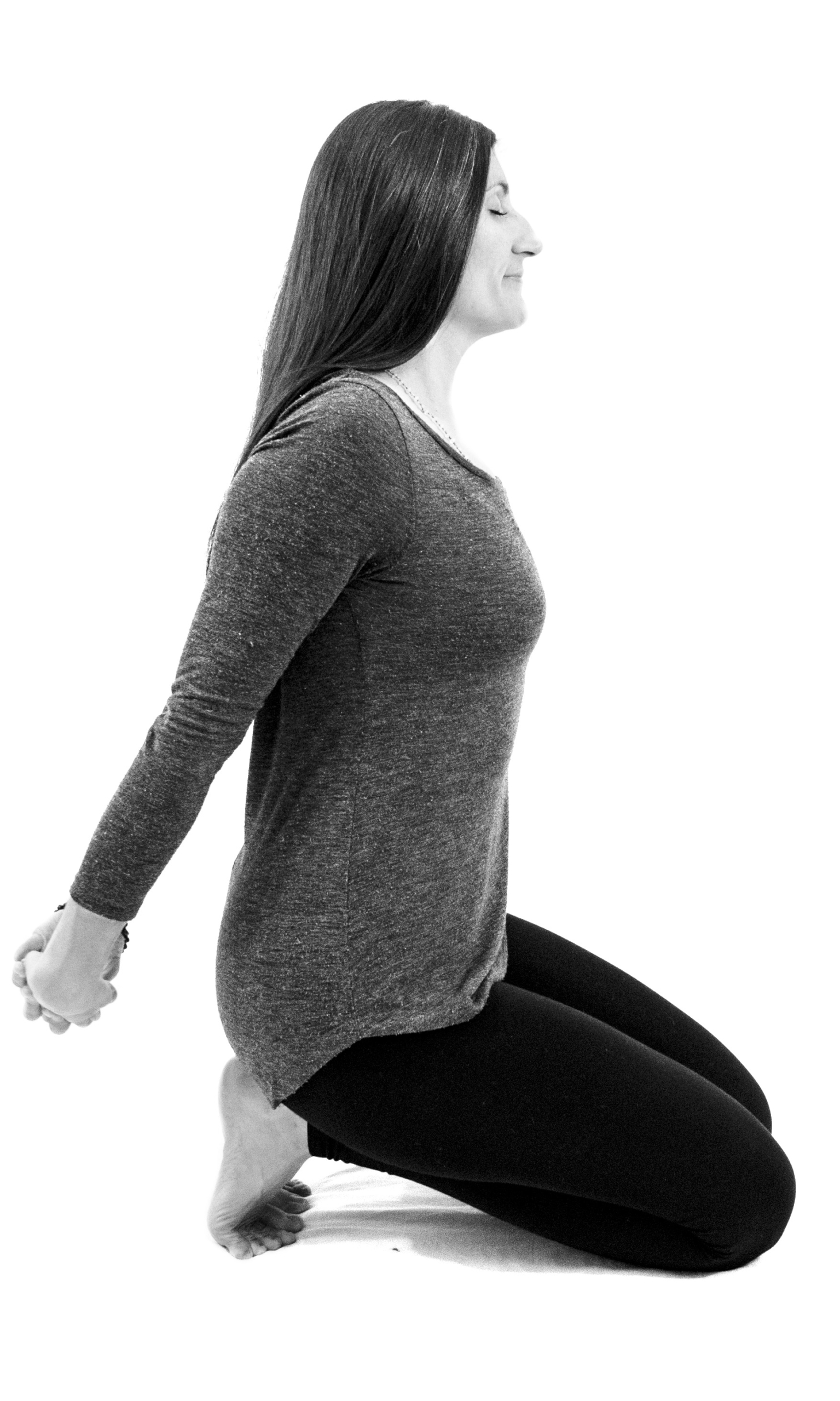 Interlace Chest and Shoulder Stretch, fingers interlaced with arms lengthened away from buttocks, toes tucked under
